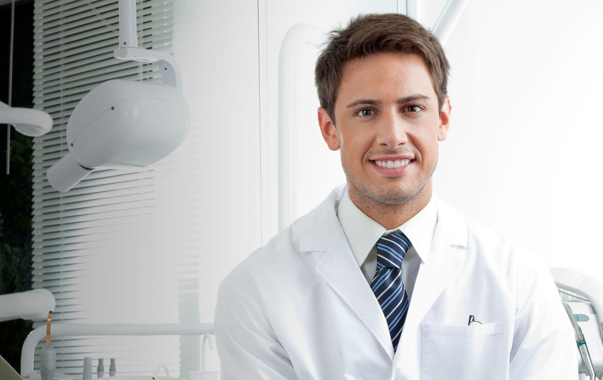 Experienced dentist smiling confidently in a modern dental office