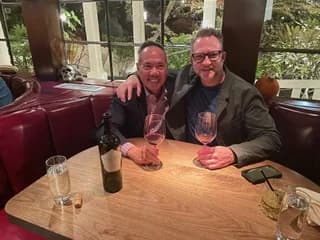 Dr. Michael Njo sharing dinner with a colleague at a restaurant
