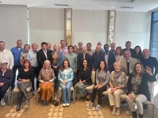 Dr. Michael Njo with a large group of dental professionals gathered at a Dugoni-related community event