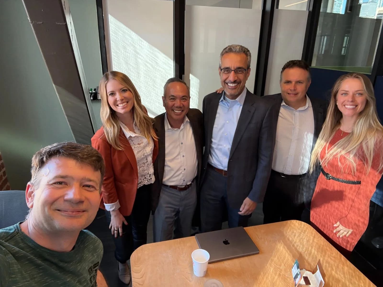 Candid office photo of Dr. Michael Njo with an AI startup founder and board of directors, including Nader Nadershahi, former Dean of the University of the Pacific School of Dentistry