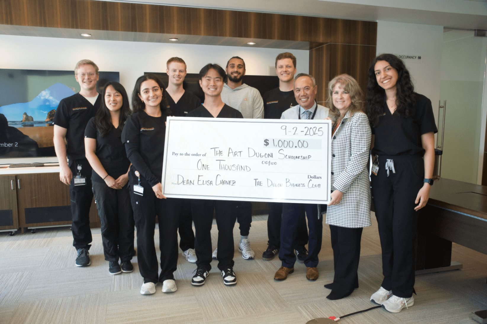 Dugoni Business Club members presenting a donation check to the Arthur A. Dugoni School of Dentistry