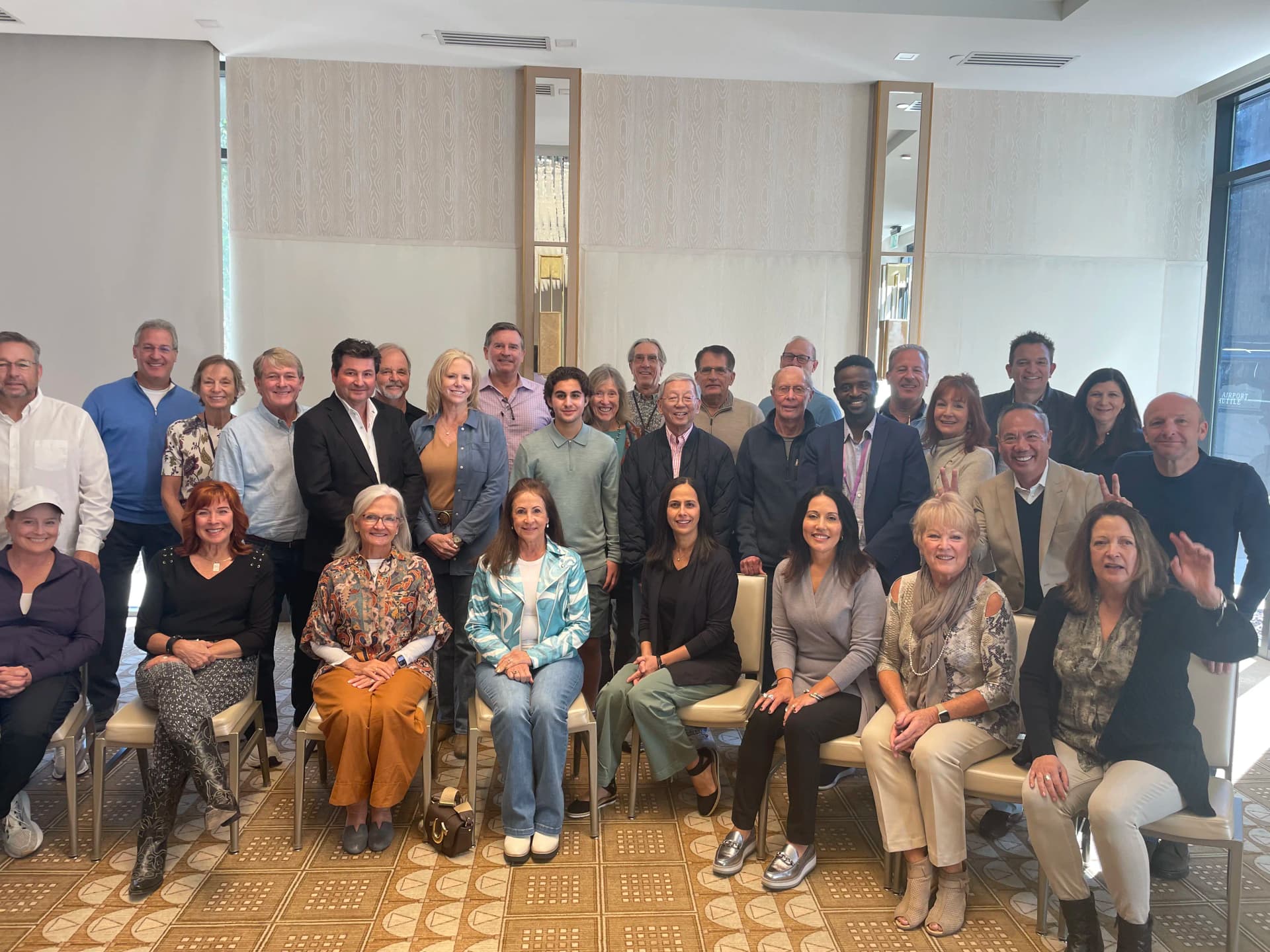 Dr. Michael Njo with a large group of dental professionals gathered at a leadership retreat