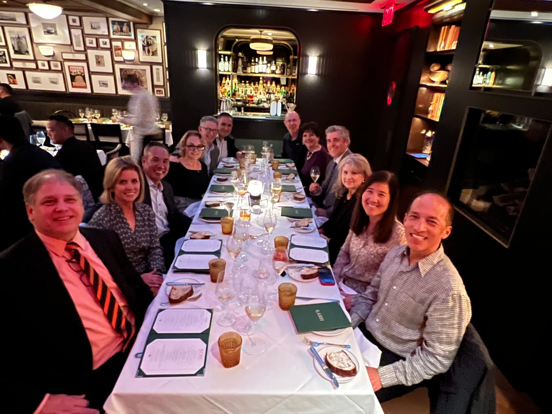Dr. Michael Njo with University of the Pacific alumni board members around a long dinner table
