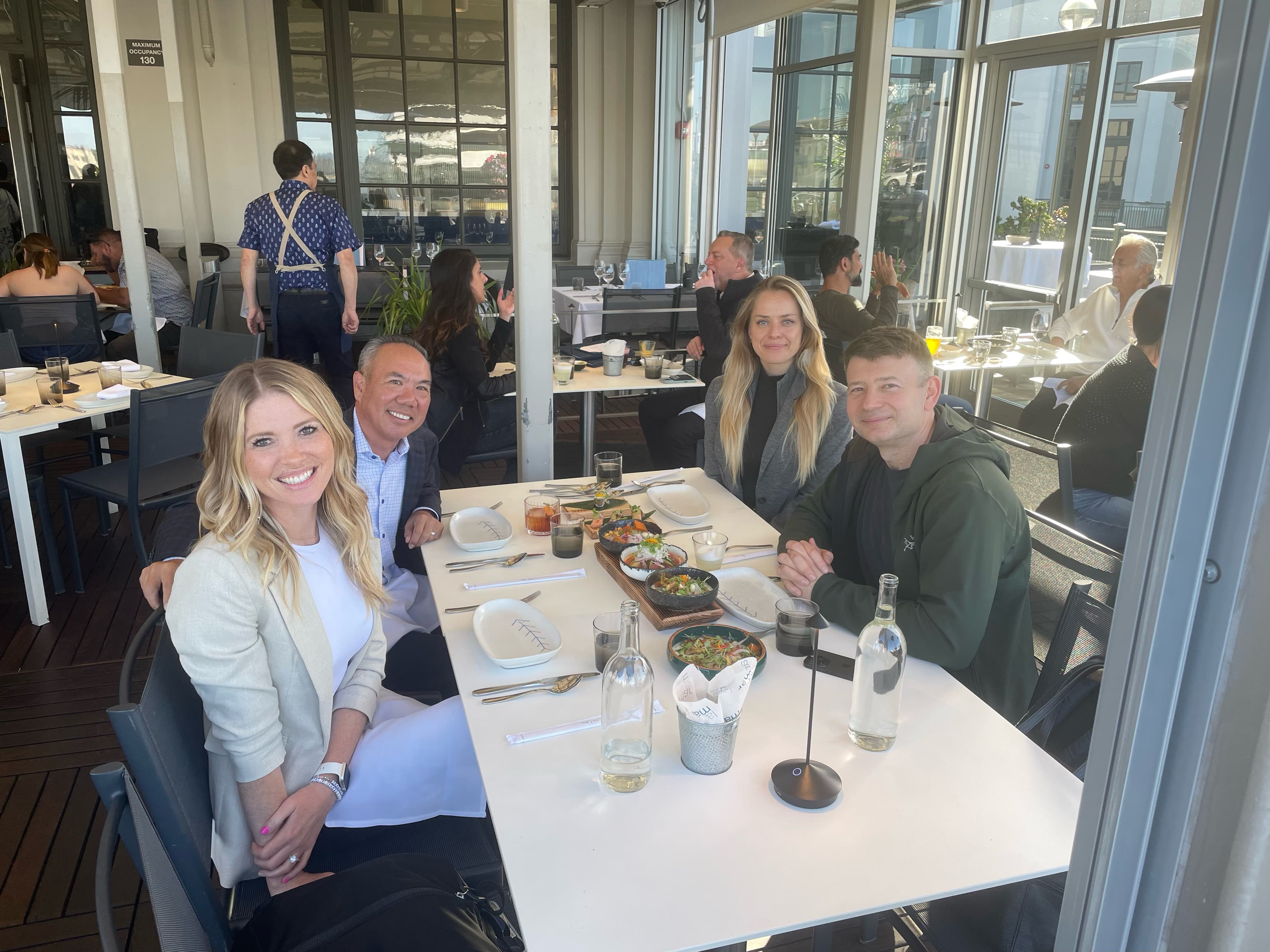 Michael Njo and PTI team members gathering at a recent board meeting as they discuss upcoming work in the dental industry