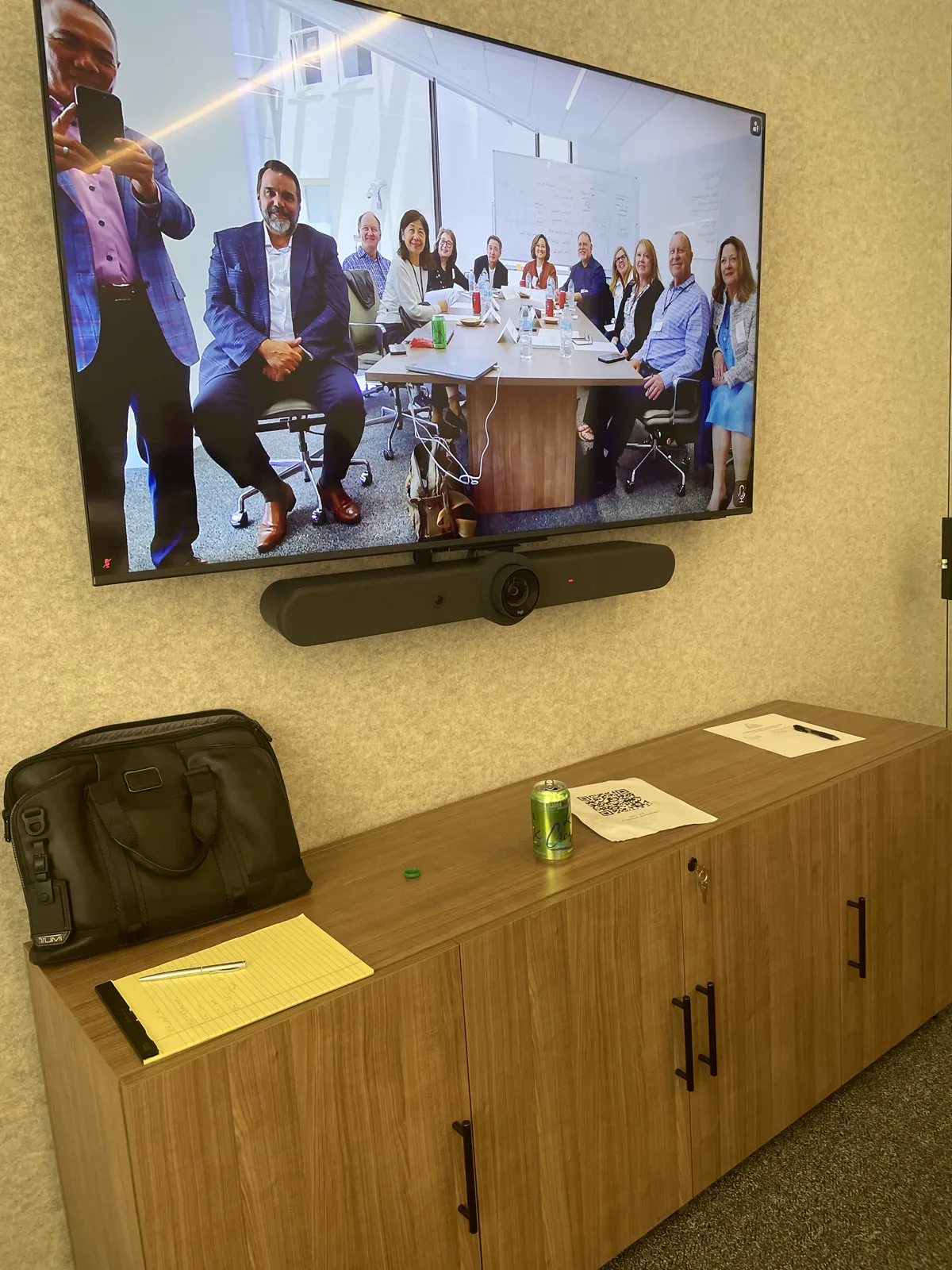 Group photo of dentists attending the July 2026 San Francisco seminar, shown on the conference room display